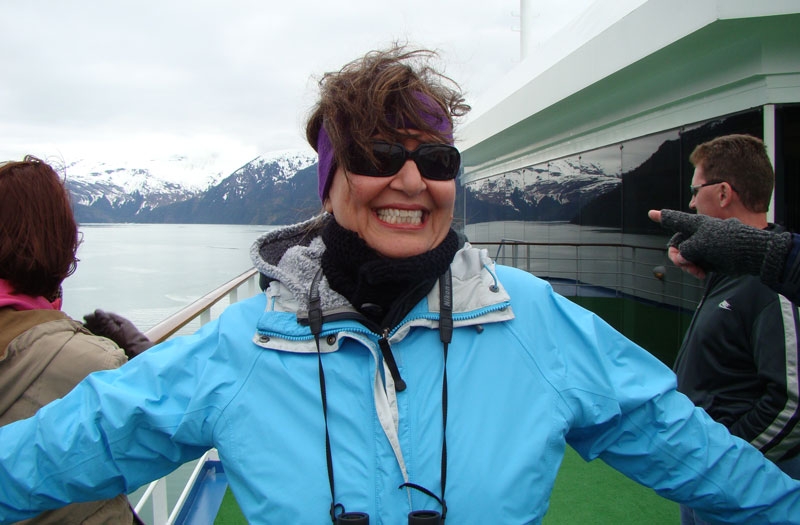 sue1.jpg - Sue enjoys the specacular views.  It was like watching a fireworks show with all the oooohs and ahhhhhs as we made each turn down the Fjord.