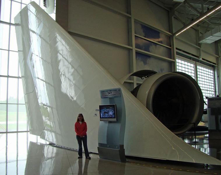 boeing1.jpg - Tonya standing next to a tail fin of a 747 at the Boeing Future of Flight Museum.